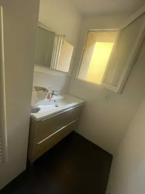 a small bathroom with a sink and a mirror at Le Nid du Peintre in Narbonne