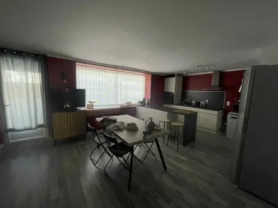 a kitchen with a table and chairs in a room at Le Nid du Peintre in Narbonne