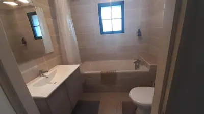 a bathroom with a sink and a tub and a toilet at Domaine Fontgrande Gîte in Carcassonne
