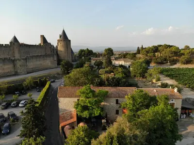 an aerial view of a town with a castle at Domaine Fontgrande Gîte in Carcassonne