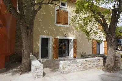 a house with two trees in front of it at Domaine Fontgrande Gîte in Carcassonne