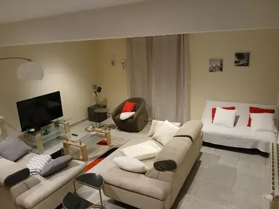 a living room with two couches and a tv at Domaine Fontgrande Gîte in Carcassonne