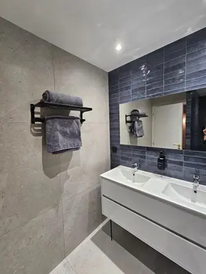 a bathroom with a sink and a mirror at Les Oreillers Multicolores in Castelnau-dʼAude
