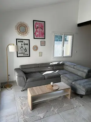 a living room with a couch and a coffee table at Le Riquet Duplex neuf climatisé au calme in Carcassonne