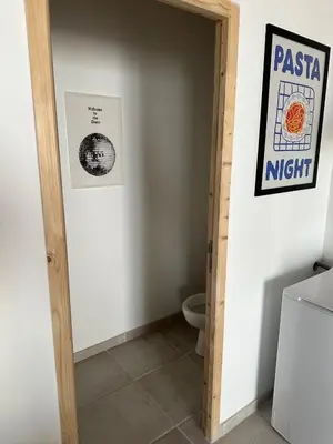 a bathroom with a door leading to a toilet at Le Riquet Duplex neuf climatisé au calme in Carcassonne