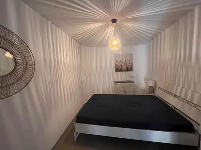 a bedroom with a bed and a mirror at Hyper centre de Narbonne in Narbonne