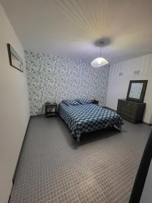 a bedroom with a bed and a lamp in it at Maison de village Olonzac in Olonzac