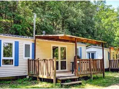 a tiny house with a porch and a deck at Chalet 6 personnes avec Terrasse - API-1-52-233 in Fenouillet