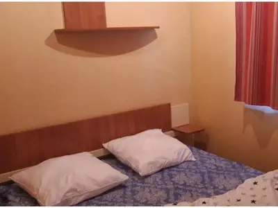 two pillows sitting on a bed in a bedroom at Mobil home confortable avec terrasse à Sournia - API-1-52-319 in Sournia