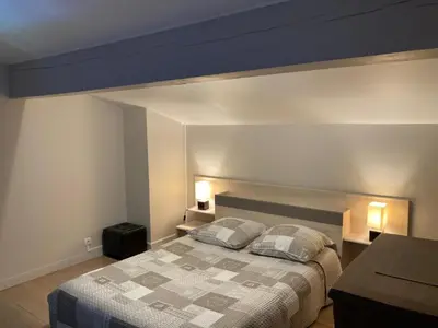 a bedroom with a large bed with two pillows at Belle vue avec piscine sécurisée in Sainte-Camelle
