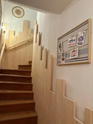 a set of stairs in a building with a clock on the wall at Charmante maison rénovée au cœur du village de Gruissan in Gruissan