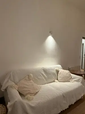 a white couch in a room with a light at appartement lumineux cosy 4 couchages coeur de narbonne in Narbonne