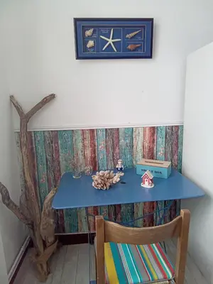 a blue table with a chair in a room at Chambre la plage in Limoux