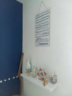 a shelf in a room with a sign on the wall at Chambre la plage in Limoux