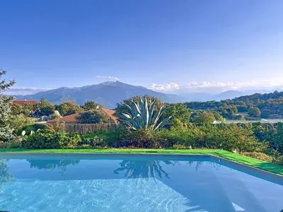 a swimming pool with a view of the mountains at Entre mer et montagnes in Arboussols