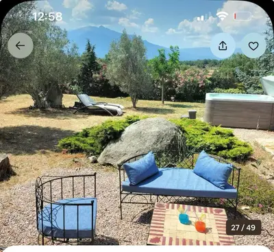 a blue couch and a chair in a yard at Entre mer et montagnes in Arboussols