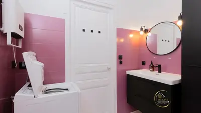 a pink bathroom with a toilet and a sink at Heart of Oc Mistral Elegant & Spacious Center Train Station in Narbonne