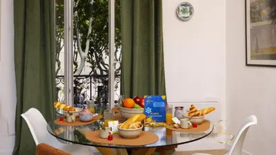 a glass table with bowls of food on it at Heart of Oc Mistral Elegant & Spacious Center Train Station in Narbonne