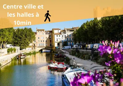 a picture of a river with boats and buildings at Heart of Oc Mistral Elegant & Spacious Center Train Station in Narbonne