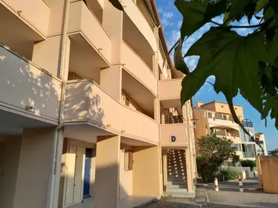 a building with balconies on the side of it at Petit appartement entre mer et montagne in Port-la-Nouvelle