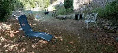 a chair and a chair sitting in a yard at Chambres d'hôtes Las Carbounieros