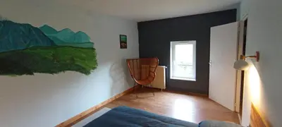 a living room with a painting on the wall at Chambres d'hôtes Las Carbounieros