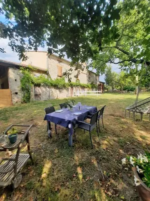 a blue table and chairs in a yard at Studio Garrevaques Calme et Charme à la Campagne - Lauren in Garrevaques