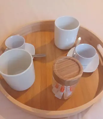 a wooden tray with cups and utensils on a table at Studio Garrevaques Calme et Charme à la Campagne - Lauren in Garrevaques