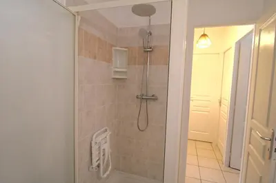 a bathroom with a shower with a shower head at Villa l'Oranger in Sigean