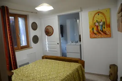 a bedroom with a bed and a sink in it at Violette in Saint-Pierre-de-Trivisy