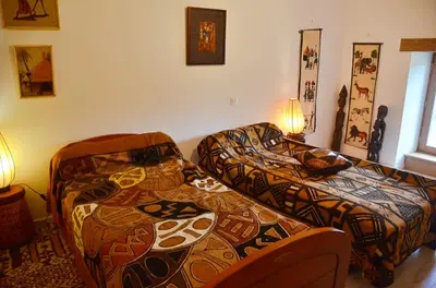 a living room with two beds and a couch at Violette in Saint-Pierre-de-Trivisy