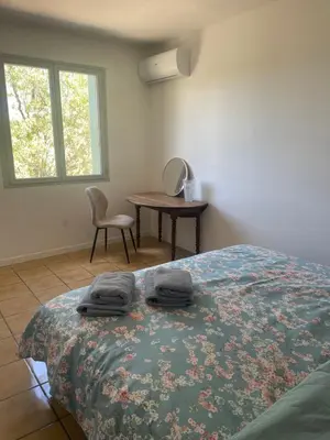a bedroom with a bed with two towels on it at Le Plô in Couffoulens