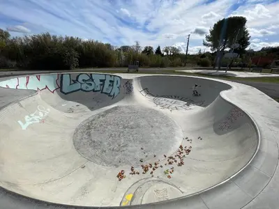 a skate park with graffiti on the side of it at Le Plô in Couffoulens