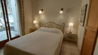 a bedroom with a white bed and two lamps at Gite Mimosa in South of France - Entire Holiday Home in Sainte-Vallière