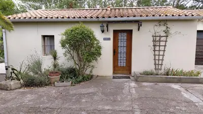 a small white house with a brown door at Gite Mimosa in South of France - Entire Holiday Home in Sainte-Vallière
