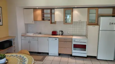 a kitchen with white appliances and a white refrigerator at Gite Mimosa in South of France - Entire Holiday Home in Sainte-Vallière