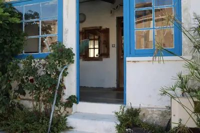 an open door of a house with a blue doorway at Authentic fisherman's house Maison de pêcheur authentique in Port-la-Nouvelle