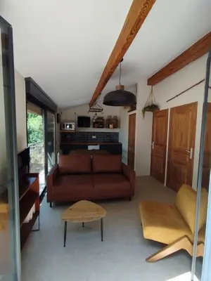 a living room with a couch and a table at Les Tournesols gîte en pleine nature in Hounoux