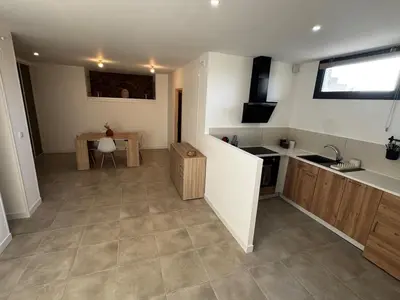 a large kitchen with a sink and a counter at Entre Campagne et Ville in Marcorignan