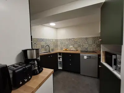 a small kitchen with a sink and a stove at La Casita Sigean in Sigean