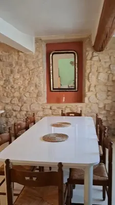 a dining room with a white table and a mirror at La Casita Sigean in Sigean
