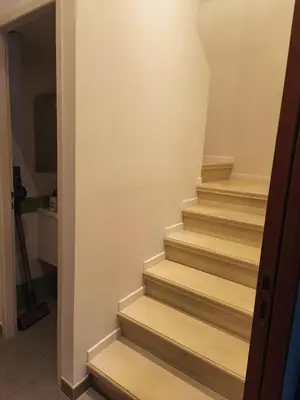 a stairway with wooden steps in a house at Le Gîte de JC in Homps