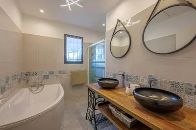a bathroom with a large sink and a tub and a bath tub at villa sophora - piscine toboggan aquatique privée in Conilhac-Corbières