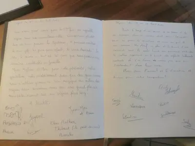 an open book with handwriting on the pages at villa la combe blanche - toboggan aquatique privée in Pépieux
