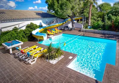 an overhead view of a swimming pool with a water slide at villa la combe blanche - toboggan aquatique privée in Pépieux