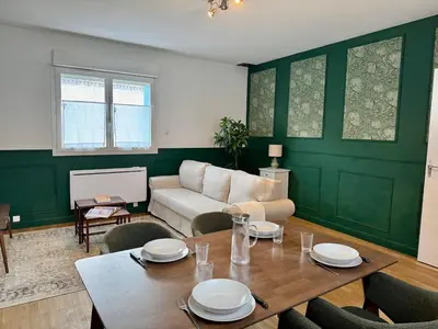 a living room with a table and a couch at Le Mahuzies 6 - Hypercentre in Castres