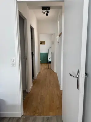 a hallway with white walls and wooden floors at Le Mahuzies 6 - Hypercentre in Castres