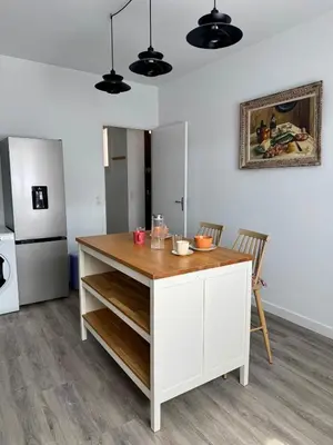 a kitchen with a white island in a room at Le Mahuzies 6 - Hypercentre in Castres