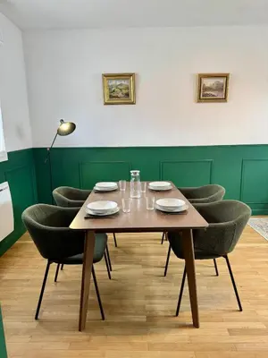 a dining room with a wooden table and chairs at Le Mahuzies 6 - Hypercentre in Castres