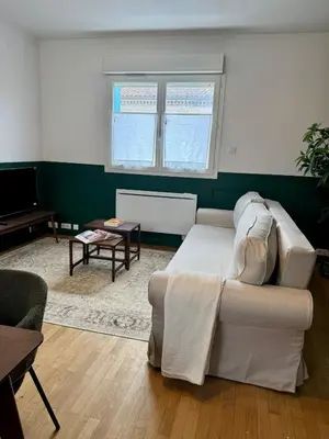 a living room with a couch and a table at Le Mahuzies 6 - Hypercentre in Castres